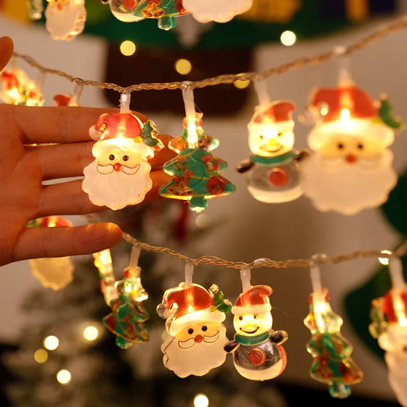 Battery-operated Christmas lights with Santa Claus, snowman, and tree designs, warm white LED garland ideal for holiday decorations.