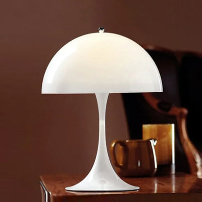 Elegant Danish-designed table lamp with sculptural silhouette on a coffee table.