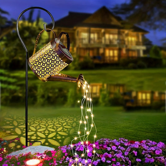 Solar-powered watering can lights with star-shaped LEDs for outdoor Christmas or garden decor.