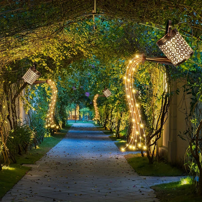 Solar-powered watering can lights with star-shaped LEDs for outdoor Christmas or garden decor.