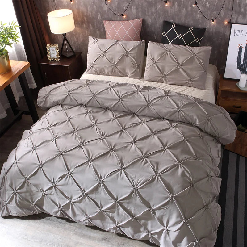 Gray diamond pintuck duvet cover set displayed on a bed, showcasing the luxurious texture and design with matching pillowcases for an elegant look.