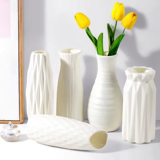 Elegant Nordic plastic flower vase in white, styled with fresh yellow tulips on a modern table setting.