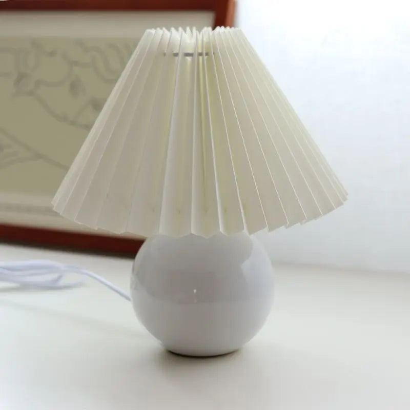 Vintage pleated table lamp with ceramic base and tricolored LED bulb, ideal for bedroom night light decor