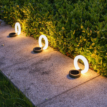 Solar outdoor atmosphere lights providing warm white illumination along a garden pathway, perfect for walkways, porches, and lawns.