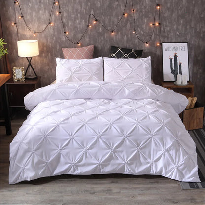 White diamond pintuck duvet cover set displayed on a bed, showcasing intricate pintuck texture and matching pillowcases for a sophisticated look.