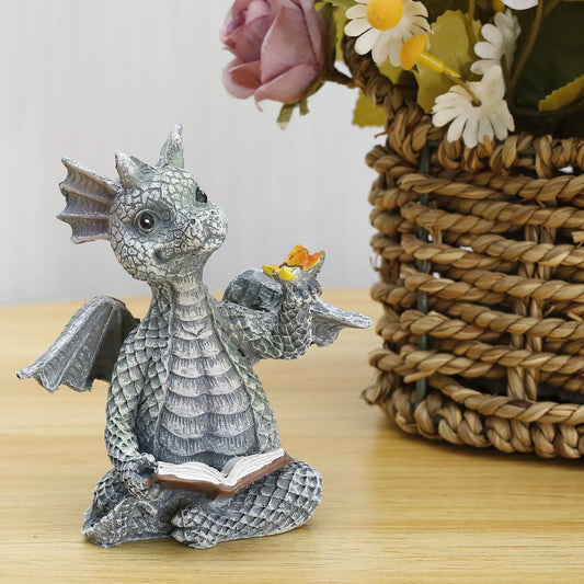 Dragon Reading Book Sculpture featuring a hand-painted resin figure of a dragon engrossed in a book, ideal for garden or indoor décor.