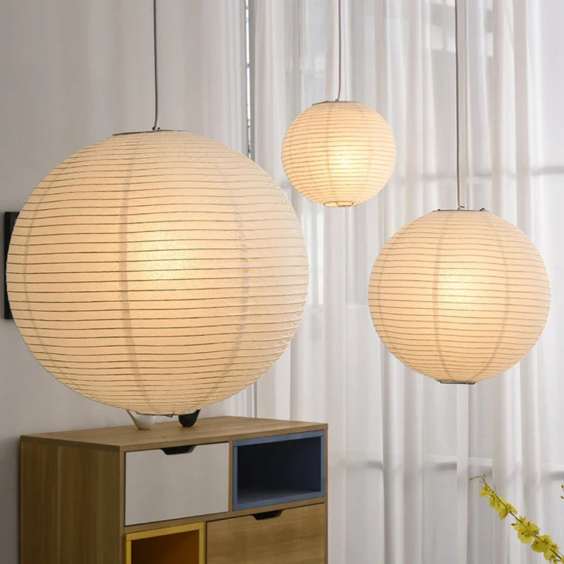 Round Nordic rice paper LED pendant light hanging in a living room, ideal for modern and minimalist home decor.