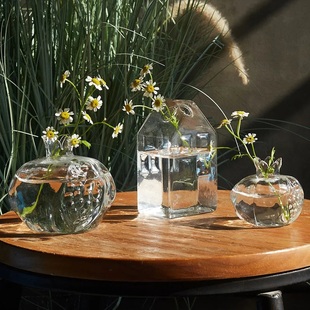 Set of transparent glass vases in angelic designs, beautifully arranged with daisies, perfect for table and desk decoration.