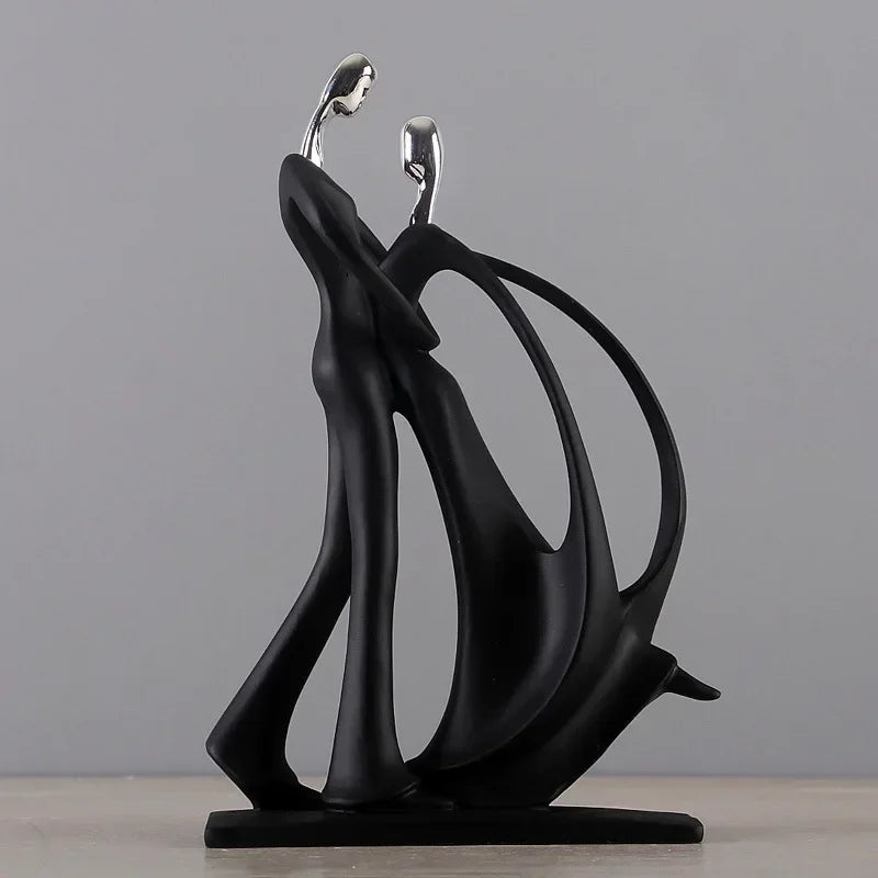 Abstract resin figurines of a dancing couple in black and metallic silver, modern home decor for living rooms and bedrooms.