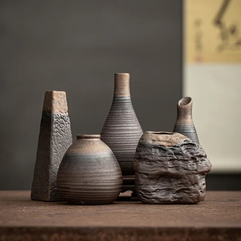 Set of handmade antique ceramic vases with rustic textures and earthy tones, perfect for modern or traditional decor.