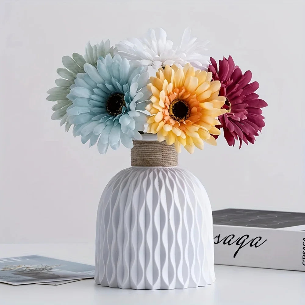 White water ripple plastic vase with vibrant flower arrangement displayed on a modern desktop.