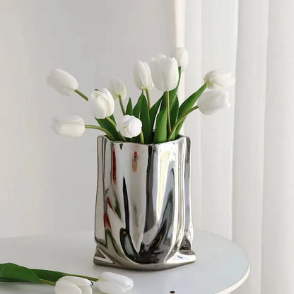 Silver ruffled ceramic vase with tulips, perfect for modern home decor and flower arrangements.