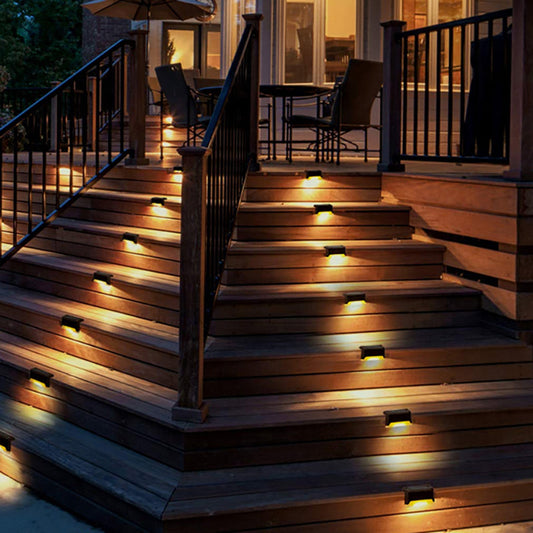 Weather-resistant solar step lights on a wooden staircase, providing soft, automatic LED lighting for outdoor safety and ambiance.