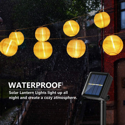 Solar-powered lantern fairy string lights illuminating a garden for Christmas or outdoor decor.