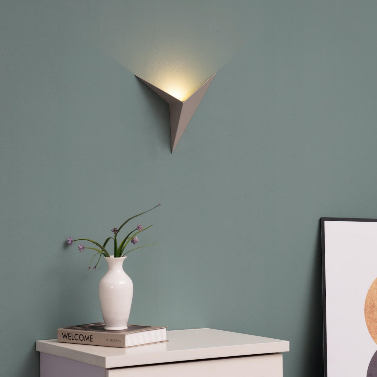 Modern triangular LED wall light in white, minimalist design with energy-efficient illumination, available in warm and cool white light options.